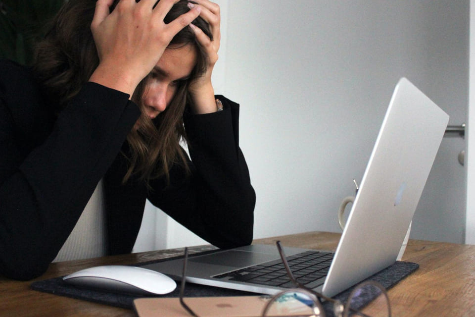 Concerned women sits by the computer