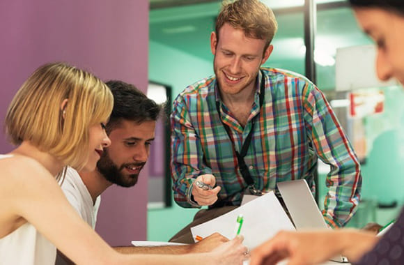 Lærer hjelper elever med en oppgave