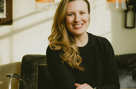 Kvinne i sort genser smiler